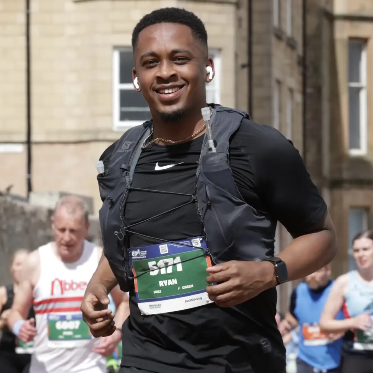 Photo of Ryan Registe smiling through the pain whilst running the Edinburgh Marathon